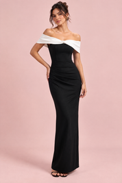 Robe longue noire à encolure Bardot, nœud et fente haute sur la cuisse | Vue de face | Lounelle Paris